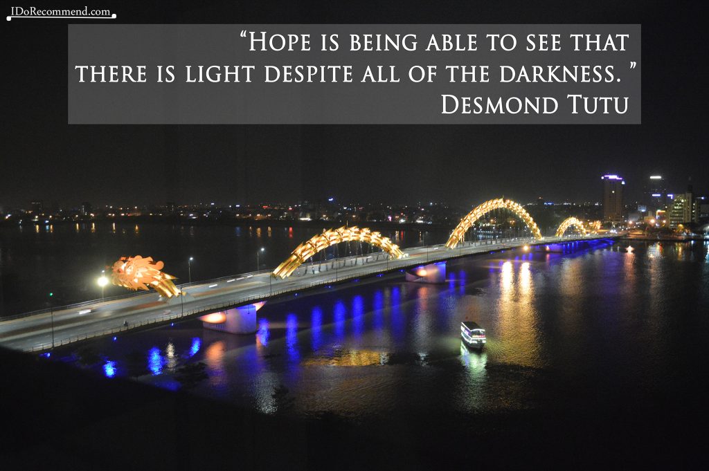 Quote "Hope is being able to see that there is light despite all of the darkness" (background Vietnam Da Nang Dragon Bridge)